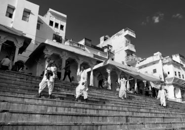 Black and White Photography with the title 'India 1'. Portrait of four indian men on stairs.